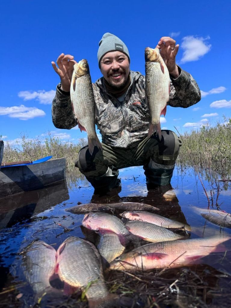 Guest holding freshly caught fish