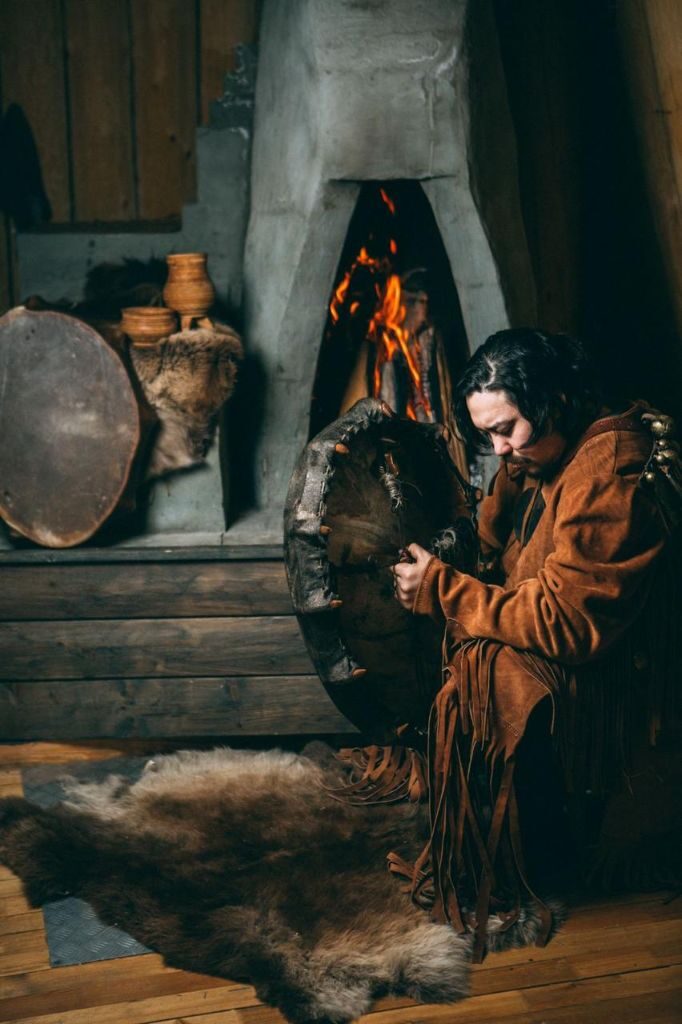 Darkhan Nikiforov with a traditional shamanic drum by firelight