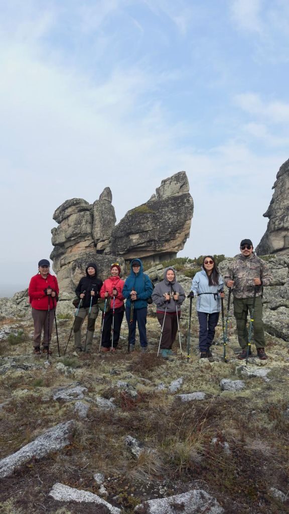 Guide standing beside a giant rock formation
